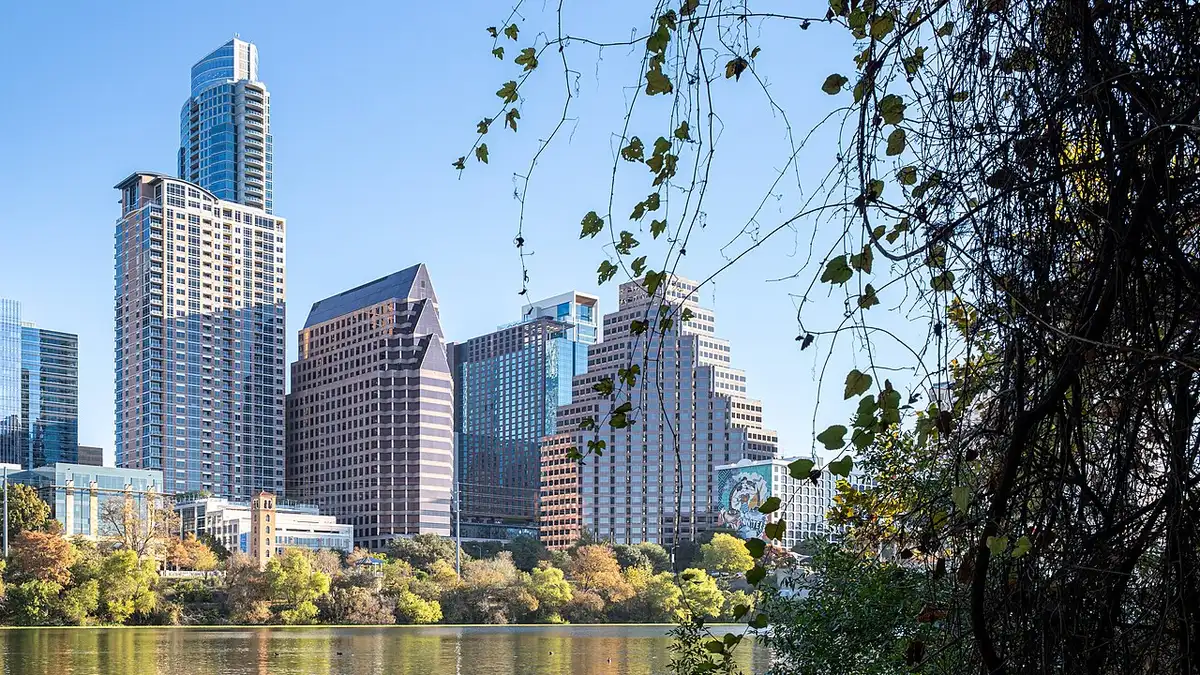 The downtown Austin skyline reflected in Lady Bird Lake at dusk